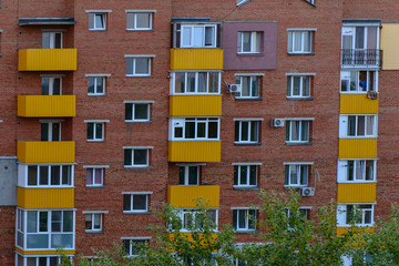 Windows blocks of living apartment building brick and yellow