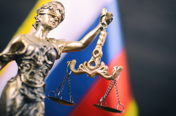 Scales of Justice, Justitia, Lady Justice in front of the Russian flag in the background.