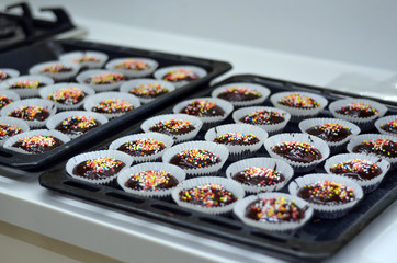 Tasty birthday chocolate cupcakes with chocolate and candies on top 
