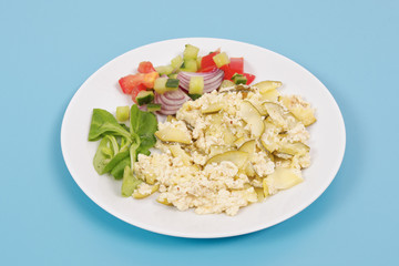 Baked zucchini vegetable salad on a white