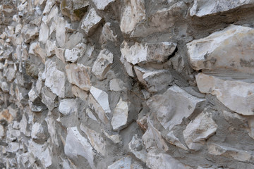 Old stone wall background texture close up