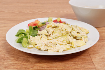 Baked zucchini vegetable salad on a white