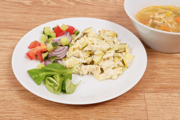 Baked zucchini vegetable salad on a white