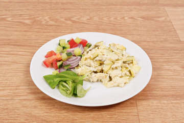 Baked zucchini vegetable salad on a white