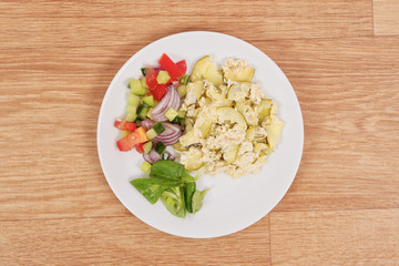 Baked zucchini vegetable salad on a white