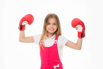 Kid athlete show power. Happy child in boxing gloves isolated on white. Little girl smile before training or workout. Childhood and childcare. Sport activity and energy