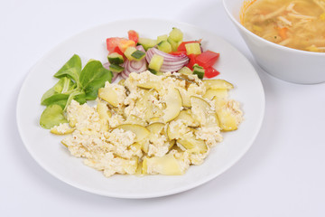 Baked zucchini vegetable salad on a white