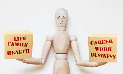 Man weighs two boxes on his hands. One with family life and other with career and work