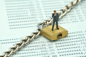 Miniature people  businessmen standing Investment Analysis Or investment Key lock and chain at the...