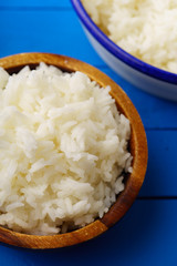 Close up image of cooked jasmin rice on blue wooden background