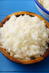 Close up image of cooked jasmin rice on blue wooden background
