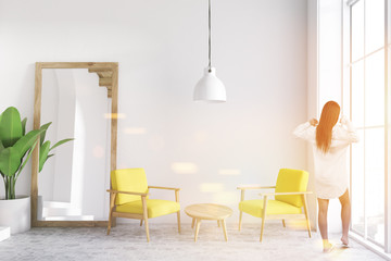 Yellow armchairs white living room, mirror, woman