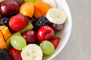  Healthy fresh fruit salad in white plate. Top view.