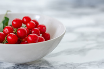 Fresh red cherries in white plate.