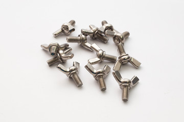 Hardware parts stainless steel winged screw bolts on white background.