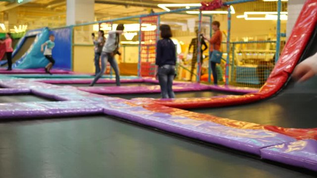 Little child girl have fun jumping on trampoline playground park for kids