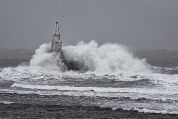  Big wave against  old Lighthouse in the port of Ahtopol, Black Sea, Bulgaria on a stormy day.
