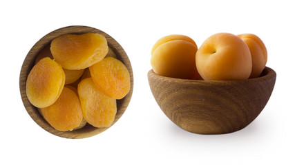 Two bowls with dried apricots and rape apricots in a wooden bowl isolated on white. Dried fruits and fresh fruits with copy space for text. Top view. 