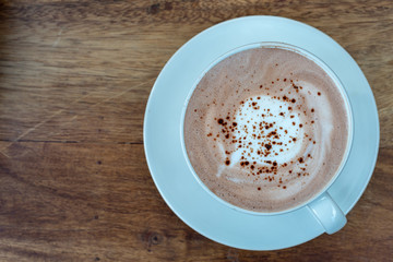 Coffee cup top view on wooden table background