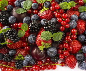 Ripe blackberries, blackberries, strawberries, red currants, peaches and plums. Mix berries and fruits. Top view. 