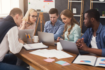 Young team discussing project in modern office