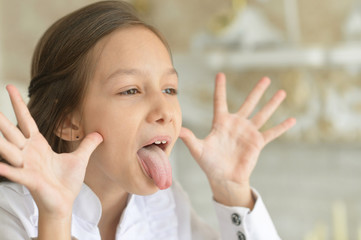 Fototapeta premium Emotional little girl in white blouse