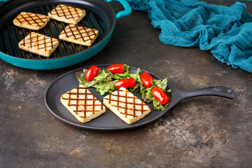 Tofu Grilled in a Cast Iron Grill Pan Served on a Cast Iron Plate with Salad