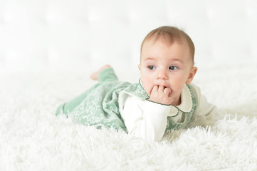 Cute little baby girl on white blanket