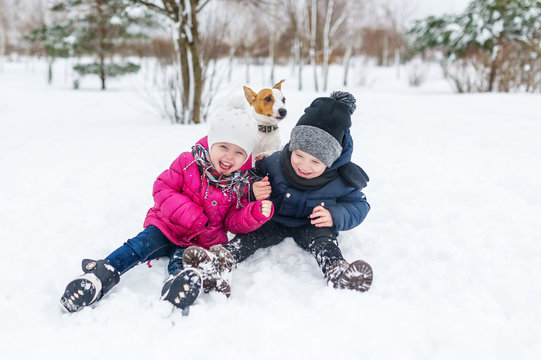 Cute Children And Dog Playing In Snow.