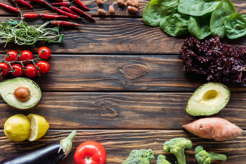 top view of arrangement of fresh and ripe vegetables on wooden surface