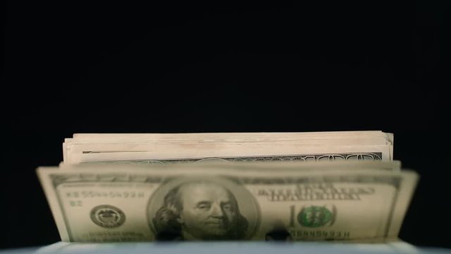 Financial banking services. Automatic cash counting machine counting 100 dollar banknotes. Modern business accounting. World commercial activity. New value proposition from bank