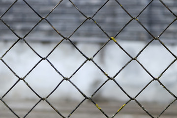 Fototapeta premium blurred abstract landscape grid fence. Metal grid texture background.
