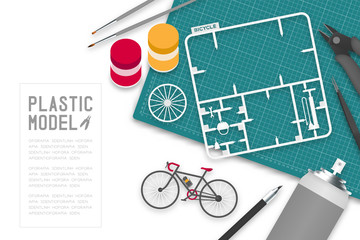Plastic model with tool kit on cutting mat, bicycle concept design illustration isolated on white background with copy space