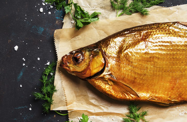 Smoked Tsimlyansky bream on dark background, top view