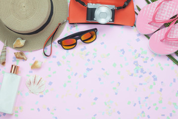 Obraz na płótnie Canvas Table top view aerial image of woman clothing for travel beach or sea in summer holiday season background concept.Flat lay essential objects on modern pink paper with confetti and copy space.