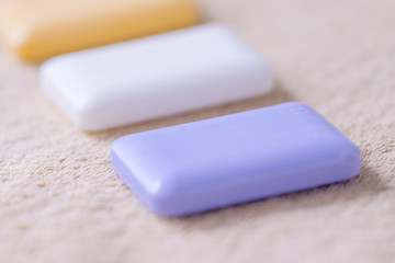 three bars of soap on a towel