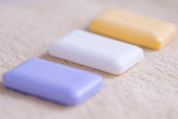 three bars of soap on a towel