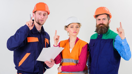 Men in hard hats, uniform and woman. Solving problems concept.