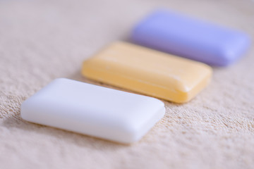 three bars of soap on a towel