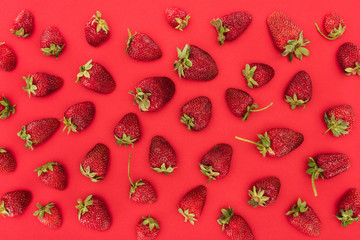 top view of raw strawberries isolated on red background