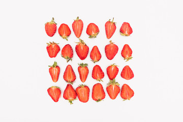 top view of fresh cut strawberries in rows isolated on white background