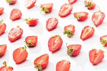 red fresh cut strawberries on white background