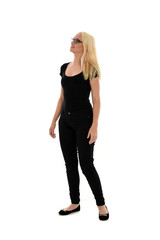 full length portrait of blonde girl wearing black clothing, isolated on white background.