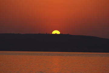 Fototapeta na wymiar a beautiful view of Gozo Island in the distance at sunset, Malta