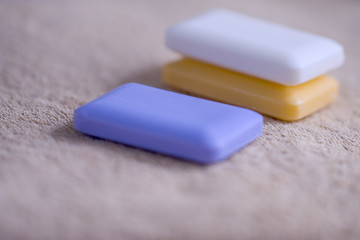 three bars of soap on a towel