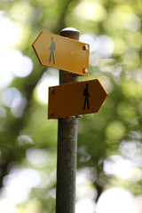 yellow trekking footpath signs in the mountains
