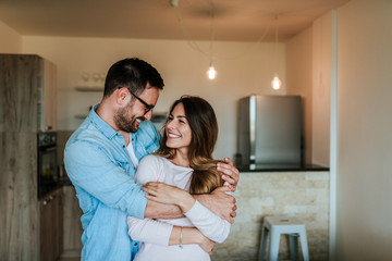 Couple hugging and looking at each other.