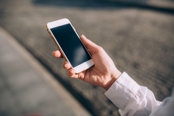 The young woman uses the smartphone