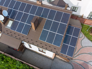 aerial view of house with solar roof. clean energy