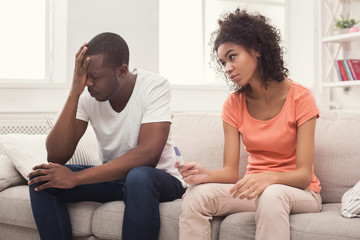 Sad black couple after pregnancy test result